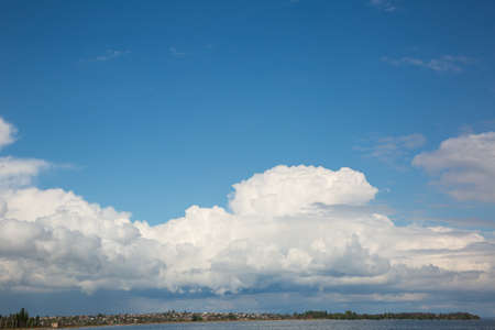 Beautiful white clouds over the river bankの写真素材