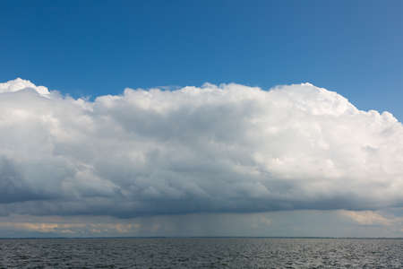 Beautiful white clouds over the river bankの写真素材