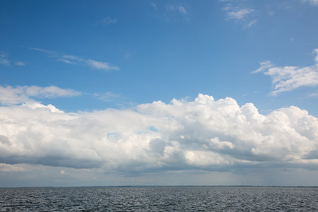 Beautiful white clouds over the river bankの写真素材