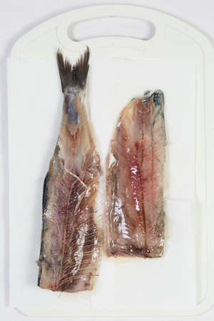 Meat and bones of fresh herring for a delicious dish, carve fishの写真素材