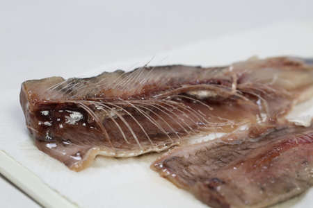 Meat and bones of fresh herring for a delicious dish, carve fishの写真素材