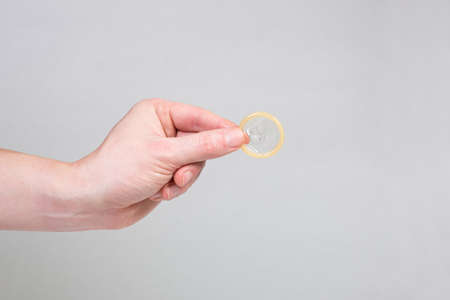 Safe sex condom in man's hand, contraceptiveの写真素材