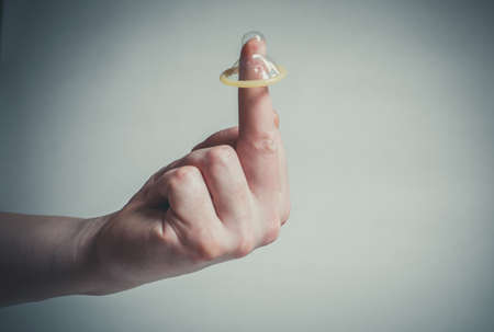 Safe sex condom in man's hand, contraceptiveの写真素材