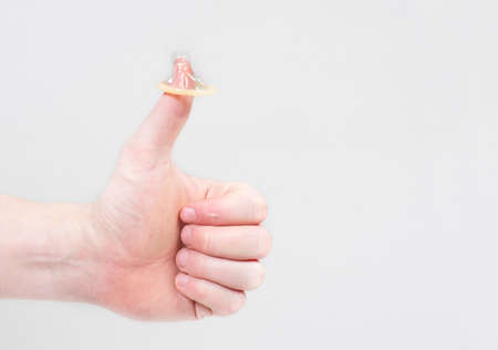 Safe sex condom in man's hand, contraceptiveの写真素材