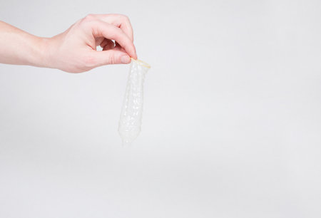 Safe sex condom in man's hand, contraceptiveの写真素材