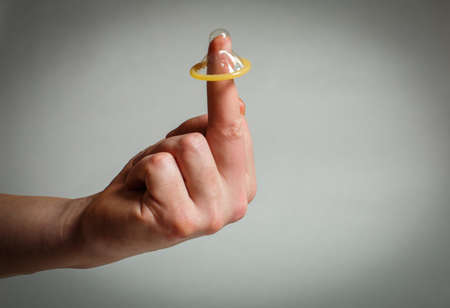 Safe sex condom in man's hand, contraceptiveの写真素材