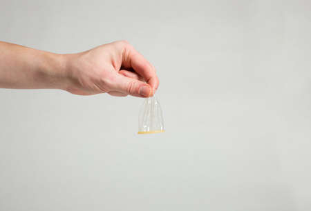 Safe sex condom in man's hand, contraceptiveの写真素材
