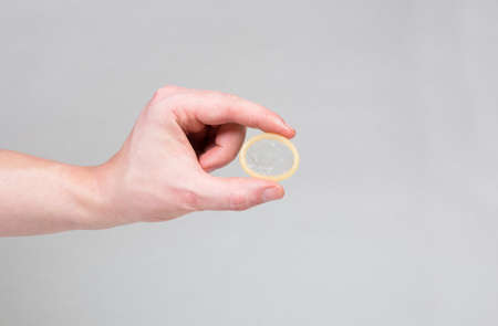 Safe sex condom in man's hand, contraceptiveの写真素材