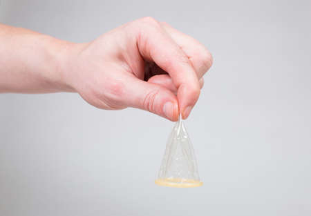 Safe sex condom in man's hand, contraceptiveの写真素材