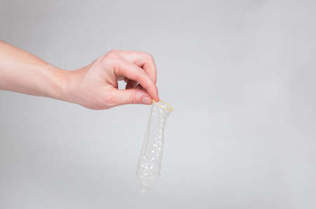 Safe sex condom in man's hand, contraceptiveの写真素材
