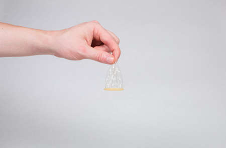 Safe sex condom in man's hand, contraceptiveの写真素材