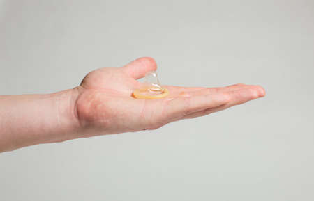 Safe sex condom in man's hand, contraceptiveの写真素材