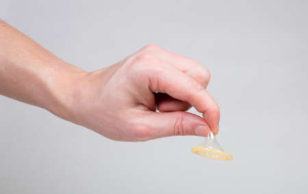 Safe sex condom in man's hand, contraceptiveの写真素材