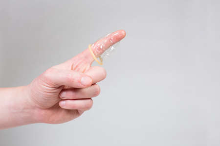 Safe sex condom in man's hand, contraceptiveの写真素材
