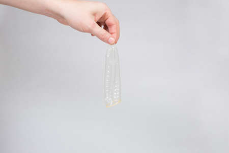 Safe sex condom in man's hand, contraceptiveの写真素材