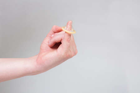 Safe sex condom in man's hand, contraceptiveの写真素材
