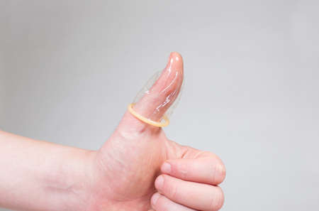 Safe sex condom in man's hand, contraceptiveの写真素材