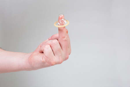 Safe sex condom in man's hand, contraceptiveの写真素材