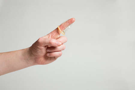 Safe sex condom in man's hand, contraceptiveの写真素材