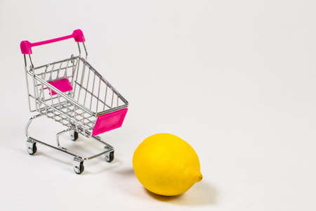 Lemon in a grocery trolley on a white backgroundの写真素材