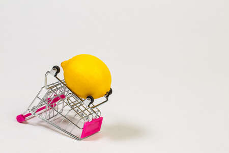 Lemon in a grocery trolley on a white backgroundの写真素材