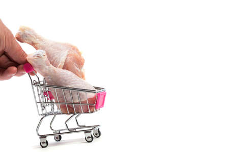 Fresh chicken meat in shopping cart isolated on white backgroundの写真素材