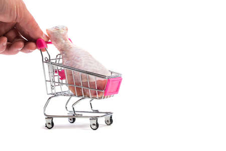 Fresh chicken meat in shopping cart isolated on white backgroundの写真素材