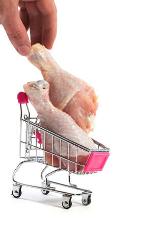 Fresh chicken meat in shopping cart isolated on white backgroundの写真素材