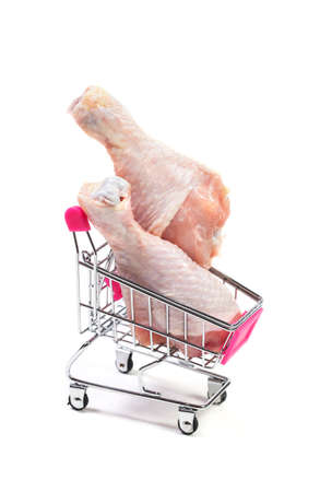 Fresh chicken meat in shopping cart isolated on white backgroundの写真素材