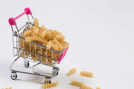 Pasta in a shopping basket on a white backgroundの写真素材