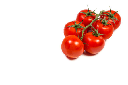 Red cherry tomatoes for salad on white backgroundの写真素材