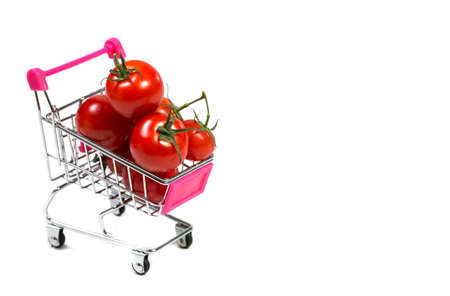 Cherry tomatoes and shopping cart on white backgroundの写真素材