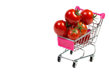 Cherry tomatoes and shopping cart on white backgroundの写真素材