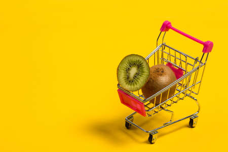 Fresh and tasty kiwi fruit on a yellow backgroundの写真素材