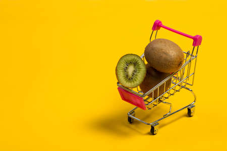 Fresh and tasty kiwi fruit on a yellow backgroundの写真素材