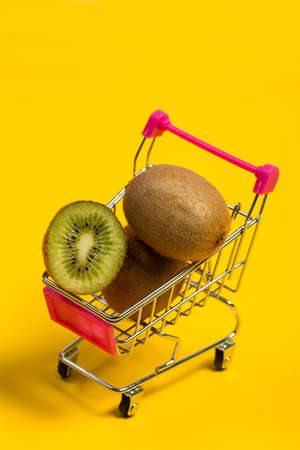 Fresh and tasty kiwi fruit on a yellow backgroundの写真素材