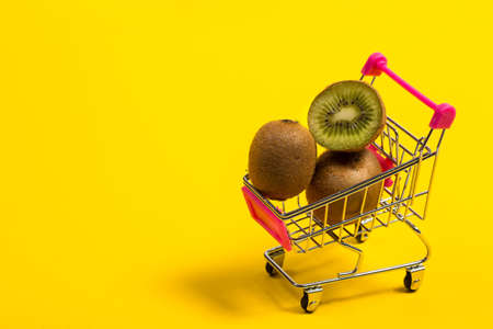 Fresh and tasty kiwi fruit on a yellow backgroundの写真素材