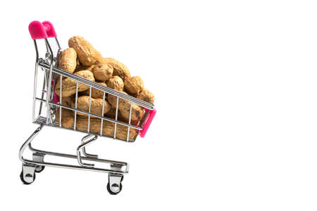 Peanuts in a shell in a shopping cart on a white background, healthy foodの写真素材
