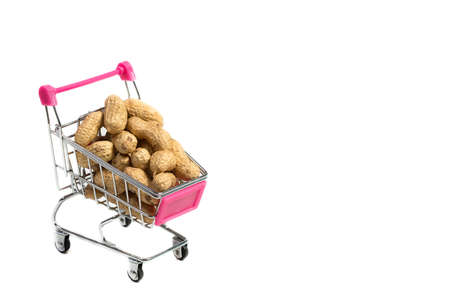 Peanuts in a shell in a shopping cart on a white background, healthy foodの写真素材