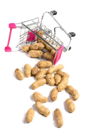 Peanuts in a shell in a shopping cart on a white background, healthy foodの写真素材