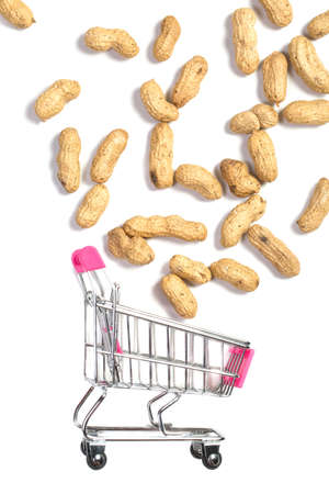 Peanuts in a shell in a shopping cart on a white background, healthy foodの写真素材