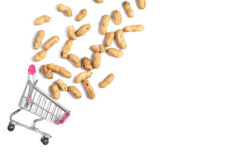 Peanuts in a shell in a shopping cart on a white background, healthy foodの写真素材