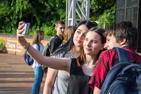 The rock concert was held in Odessa City, Ukraine, an open-air theater called the Green Theater. People on the summer terrace  take photos. 29.06.19.のeditorial素材