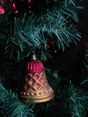 Decorative bell hanging from a Christmas treeの写真素材