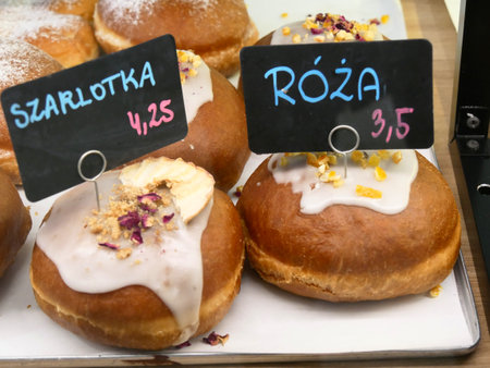 PÄczki, (pÄczek in the singular), traditional polish doughnuts, fried, plain or filled with jam or chocolate. They are and often covered with a thick sugar glaze. Slightly blurred.の写真素材