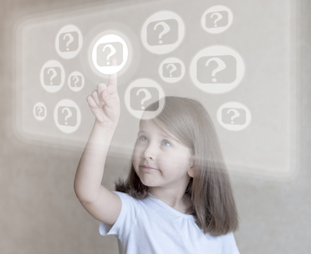 Little girl choosing icon on virtual touch screen. Baby using a touch screen interfaceの写真素材