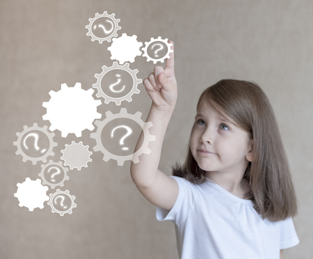 Little girl choosing icon on virtual touch screen. Baby using a touch screen interfaceの写真素材