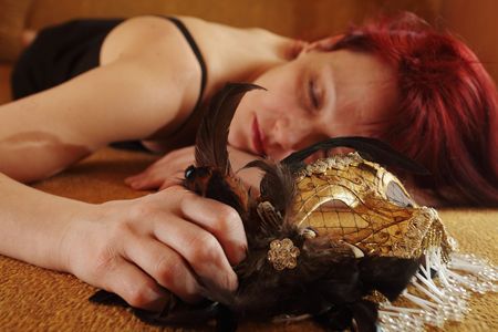 sleeping woman with golden venetian mask,focus on foregroundの写真素材