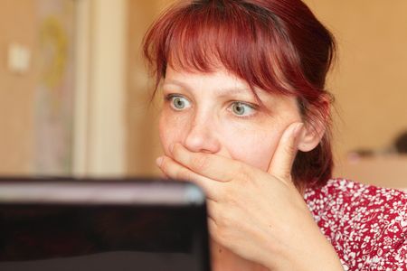 The surprised woman before a computerの写真素材