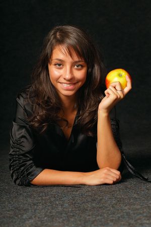 beautiful girl in black with ripe appleの写真素材